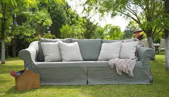 Garden furniture (sofa) in the garden on a bright sunny day