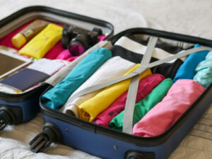 Opens suitcase full of colourful clothes