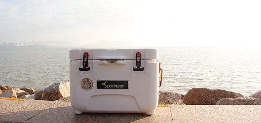White cooler with closed lid on a wall over looking the ocean
