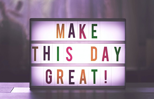 Picture of a sign saying "make this day great"