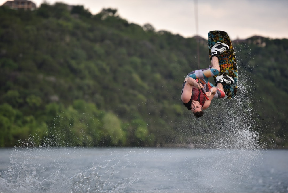 Guy doing a flip on his wakeboard