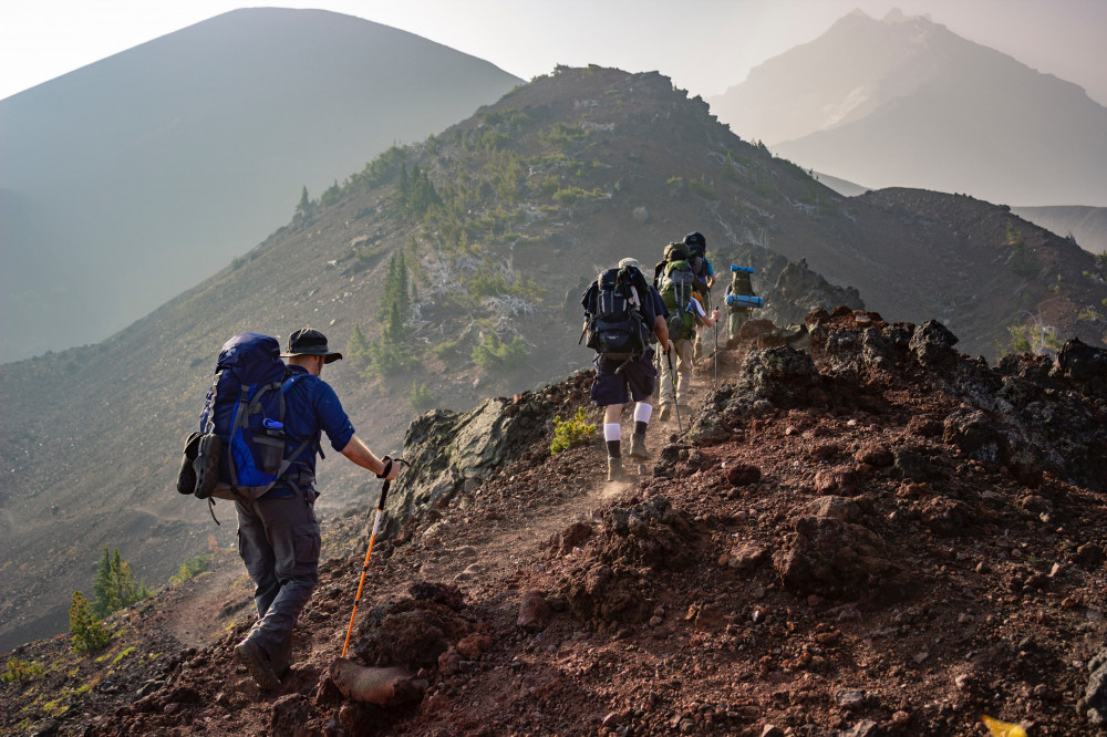 Hikers crossing a mountain path