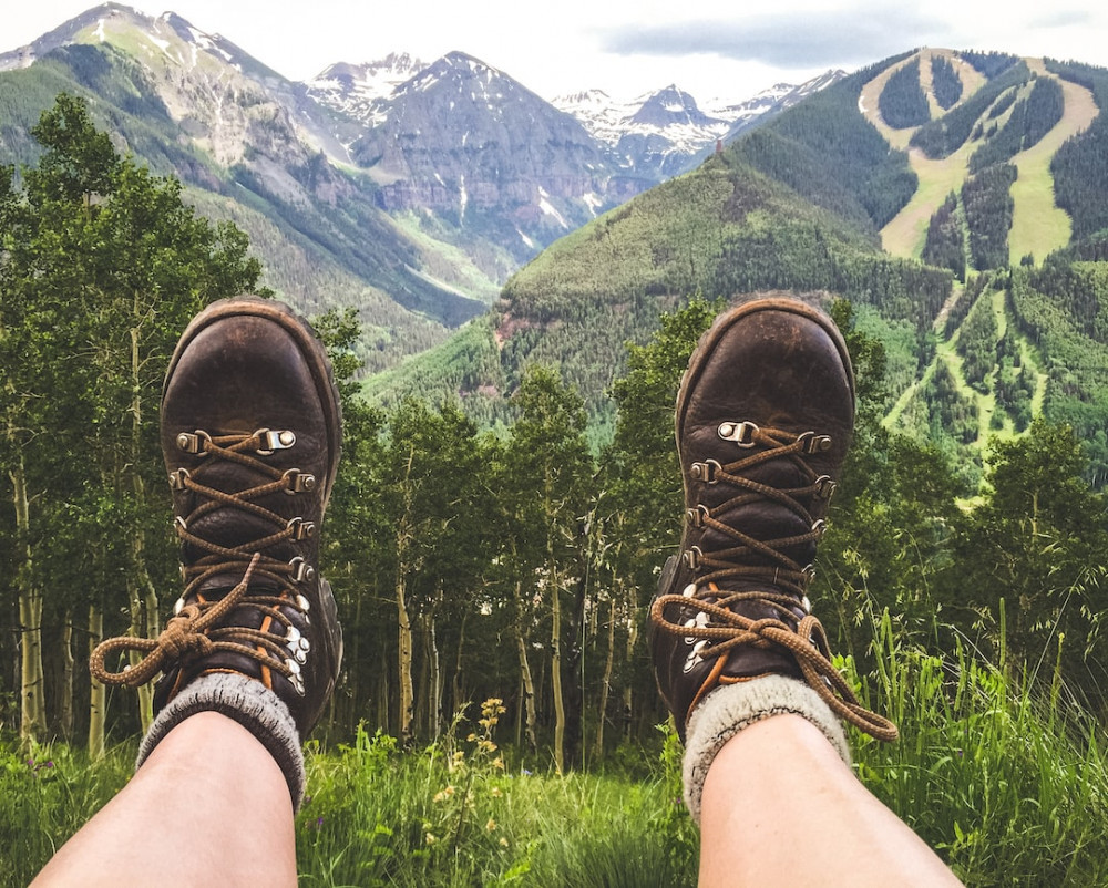 Someone taking a rest wearing their odd socks and hiking boots over-looking the landscape and enjoying the view