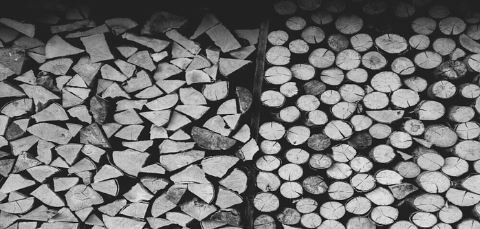 Image of unprepared wood and split wood all stacked up