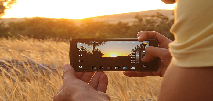 Someone taking a picture of the sunset