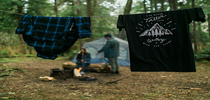 Clothing hanging on paracord drying off at a campsite