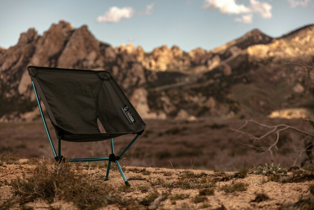 Camping chair placed on rocks surrounded by a mountainous desert
