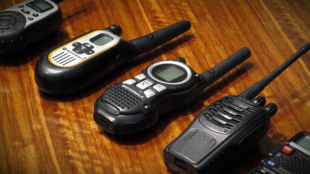 Row of satellite devices and walkie talkies